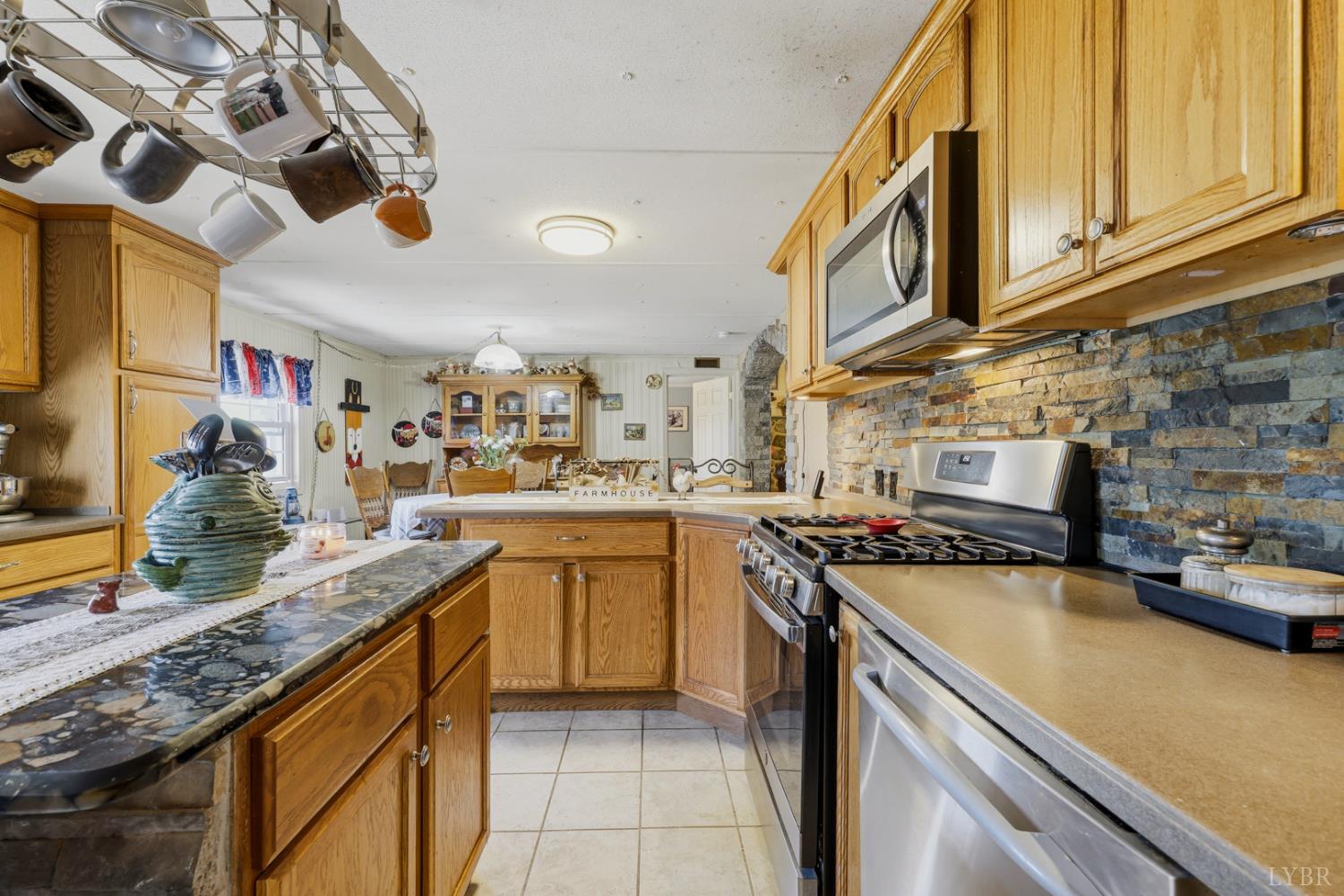 809 Plantation Road Amherst, VA 24521 - Photo 22 of 77 a kitchen with stainless steel appliances granite countertop a sink and cabinets