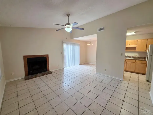 a view of a kitchen with an empty space and a fireplace