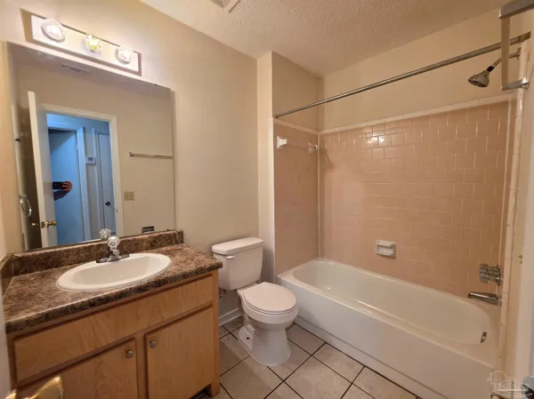 a bathroom with a granite countertop sink a toilet and shower