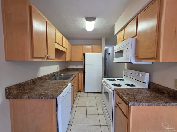 a kitchen with a stove a sink and a refrigerator