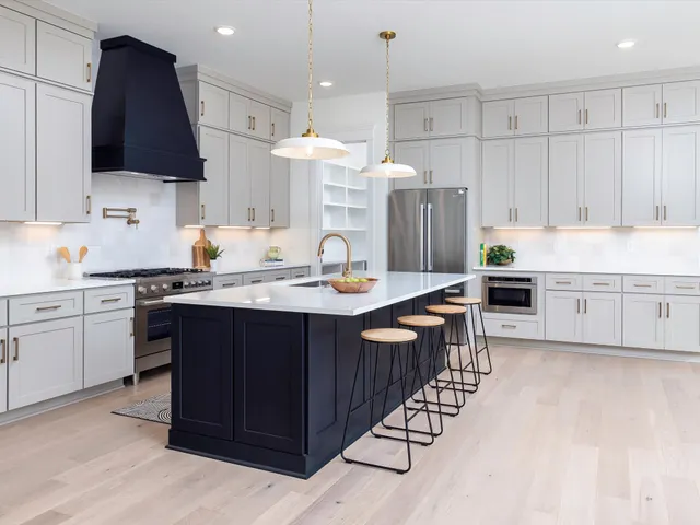 a kitchen with a dining table chairs sink and cabinets