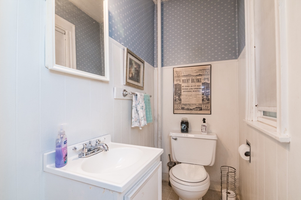 28 Rencelau Street Springfield, MA 01118 - Photo 14 of 34 a white toilet sitting next to a bathroom sink
