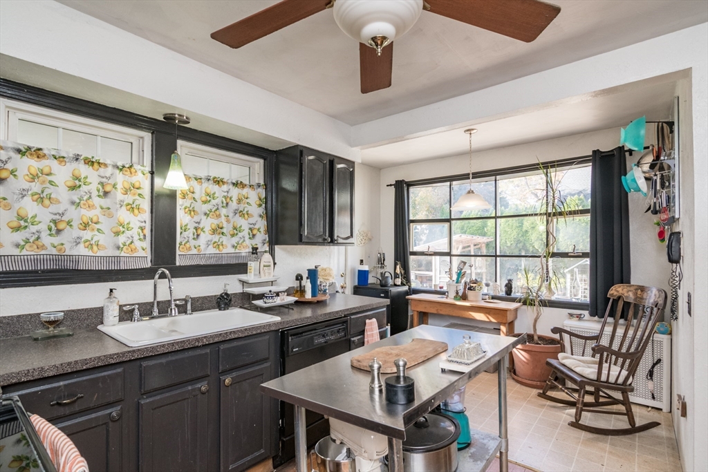 28 Rencelau Street Springfield, MA 01118 - Photo 17 of 34 a dining room with furniture a large window and a chandelier