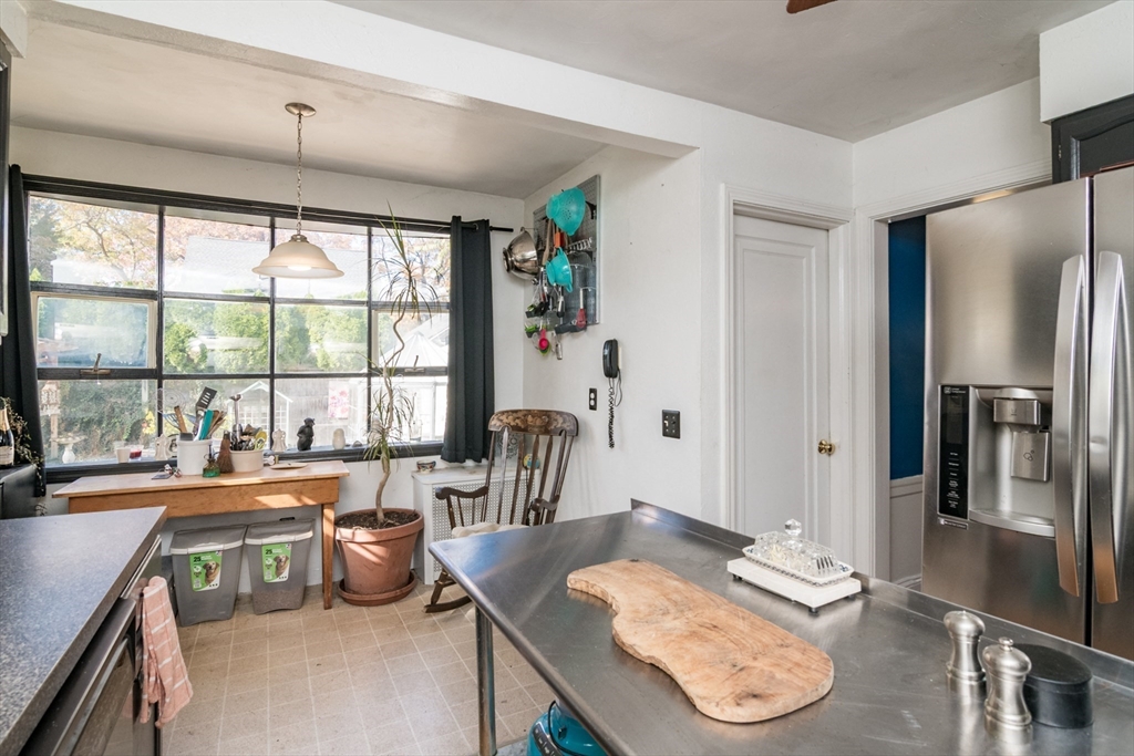 28 Rencelau Street Springfield, MA 01118 - Photo 18 of 34 a room with furniture a large window and a table