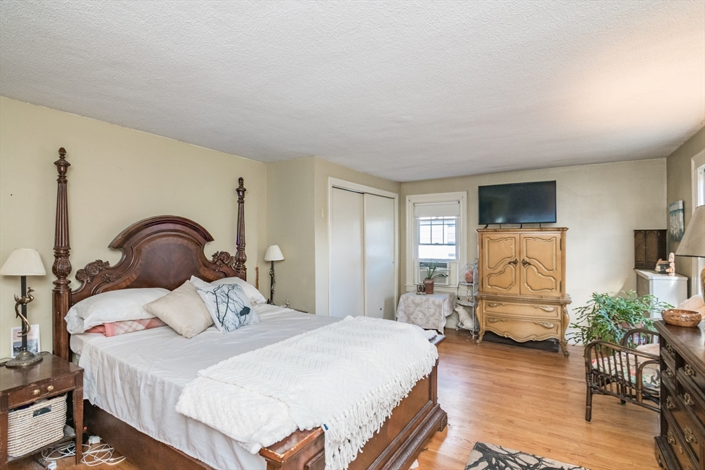28 Rencelau Street Springfield, MA 01118 - Photo 22 of 34 a bedroom with a bed and wooden floor