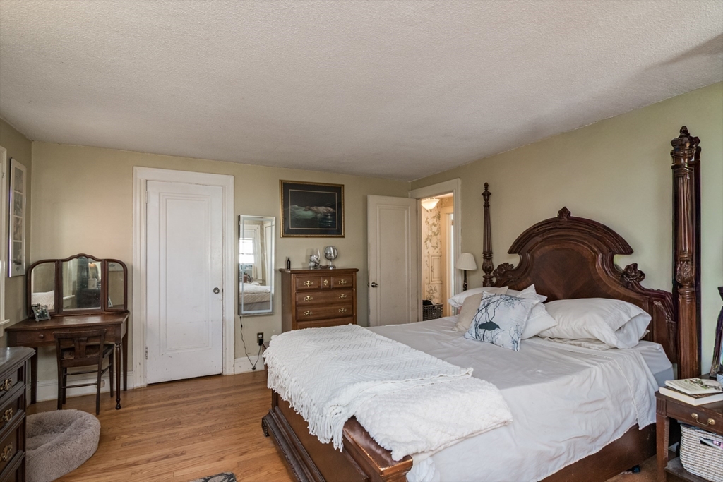 28 Rencelau Street Springfield, MA 01118 - Photo 24 of 34 a bedroom with a bed and wooden floor