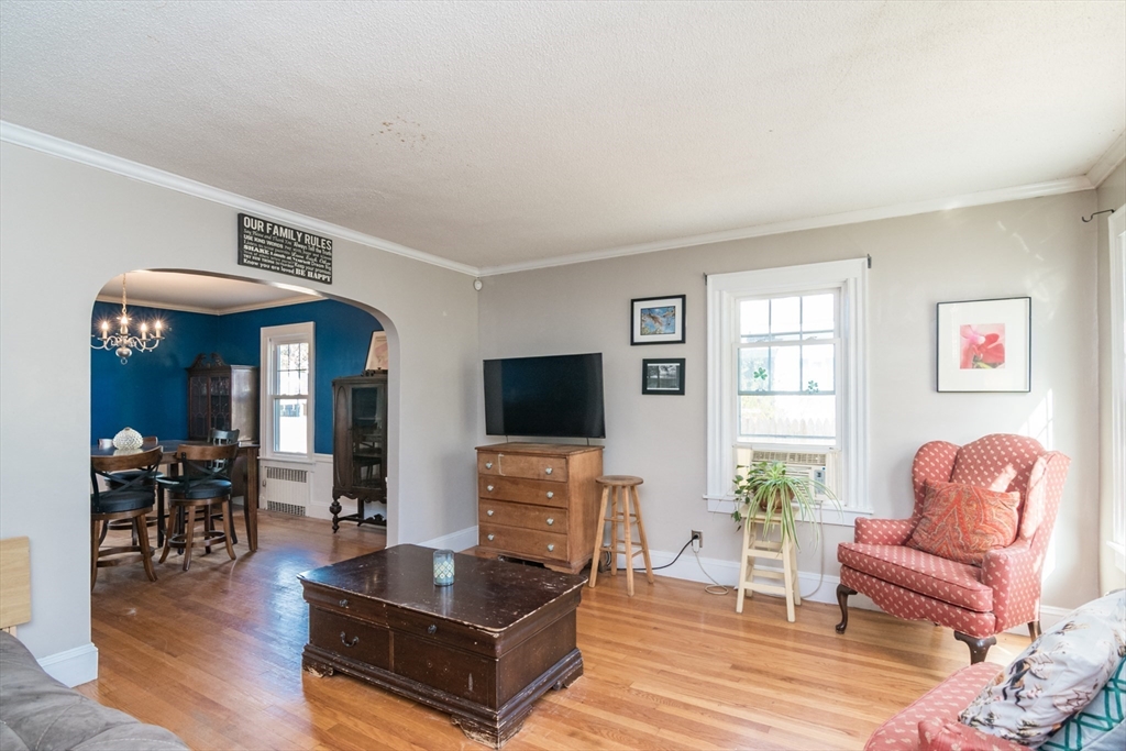 28 Rencelau Street Springfield, MA 01118 - Photo 5 of 34 a living room with furniture a wooden floor and a flat screen tv