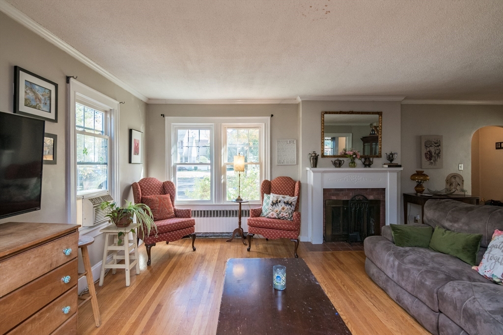 28 Rencelau Street Springfield, MA 01118 - Photo 8 of 34 a living room with furniture and a fireplace