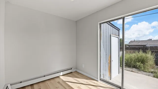 a view of room with window and wooden floor