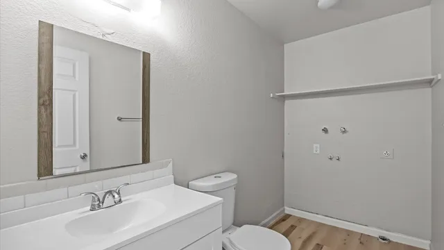 a bathroom with a sink toilet and shower