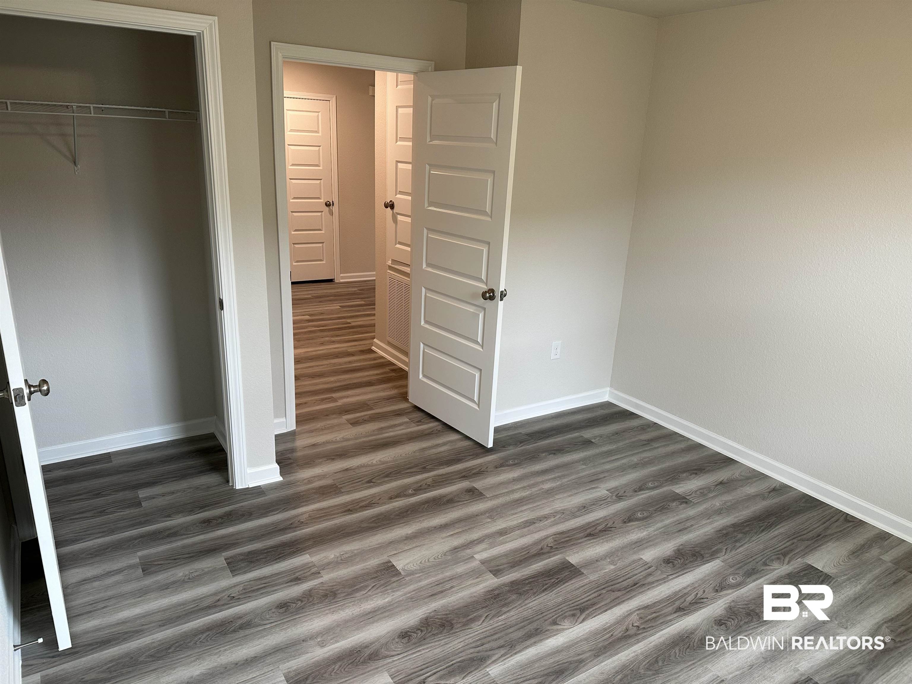 1238 Hayward Loop Foley, AL 36535 - Photo 18 of 46 Unfurnished bedroom with a closet and dark wood-type flooring