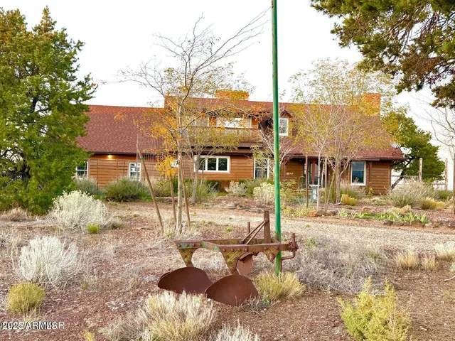 a view of a patio with table and chairs and wooden fence