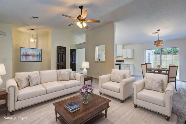 a living room with furniture a lamp and a chandelier