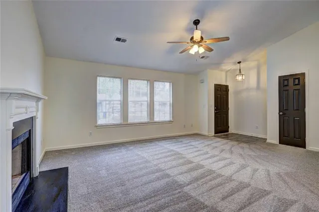 a view of empty room with a fireplace