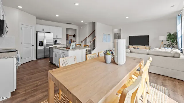 a dining room with furniture wooden floor and a rug