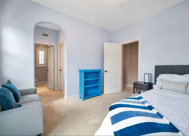 a bedroom with a bed and a couch