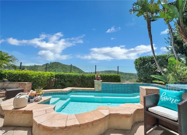 a view of a two chairs in a park