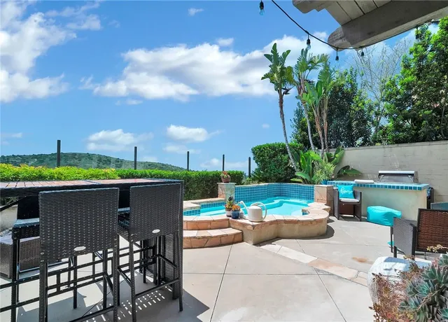 a view of a patio with table and chairs and potted plants