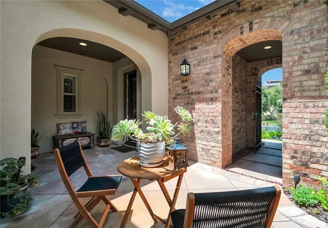 a view of a porch with furniture and a potted plant