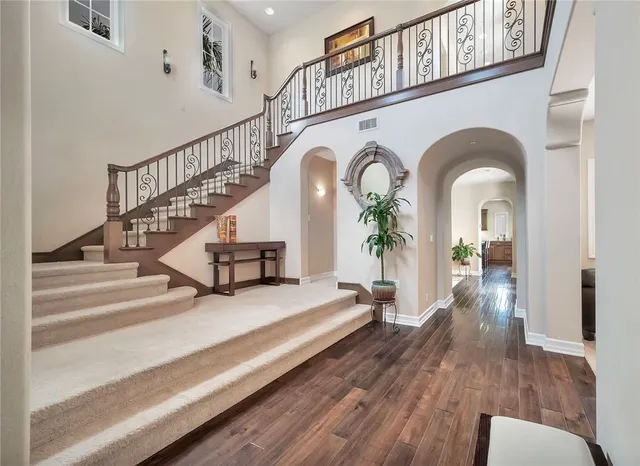 a view of entryway and hall with wooden floor
