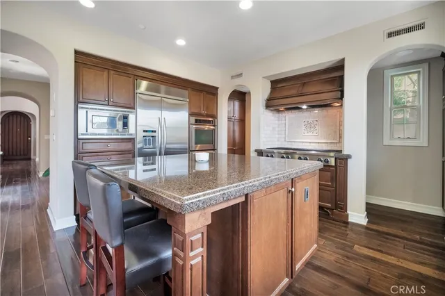 a kitchen with stainless steel appliances granite countertop a stove and a refrigerator