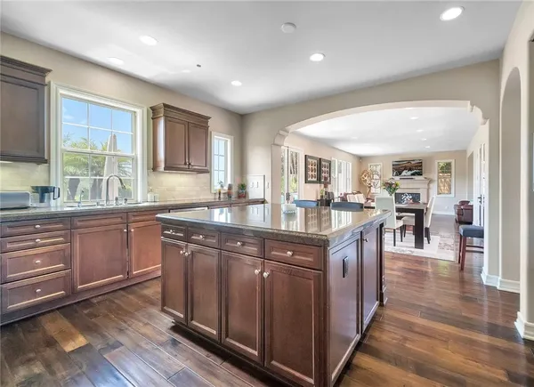 a kitchen with lots of counter top space and wooden floor