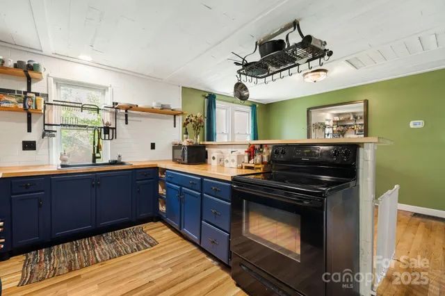 a kitchen with stainless steel appliances granite countertop wooden cabinets stove and sink