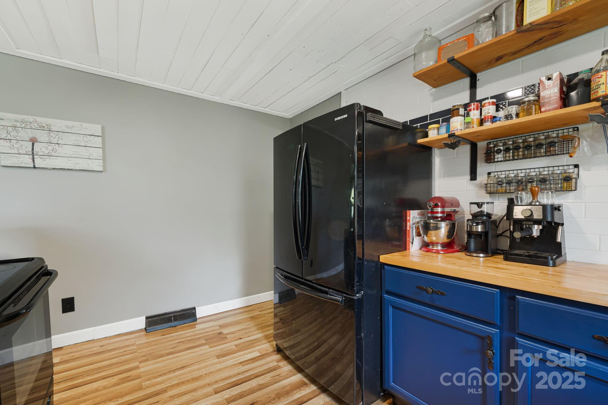 1271 Upper Brush Creek Road Fairview, NC 28730 - Photo 15 of 36 a room with wooden floor and gym equipment