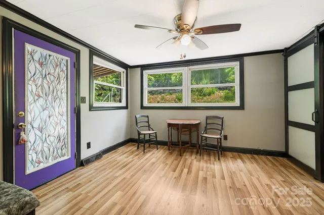 a view of a livingroom with furniture window and wooden floor