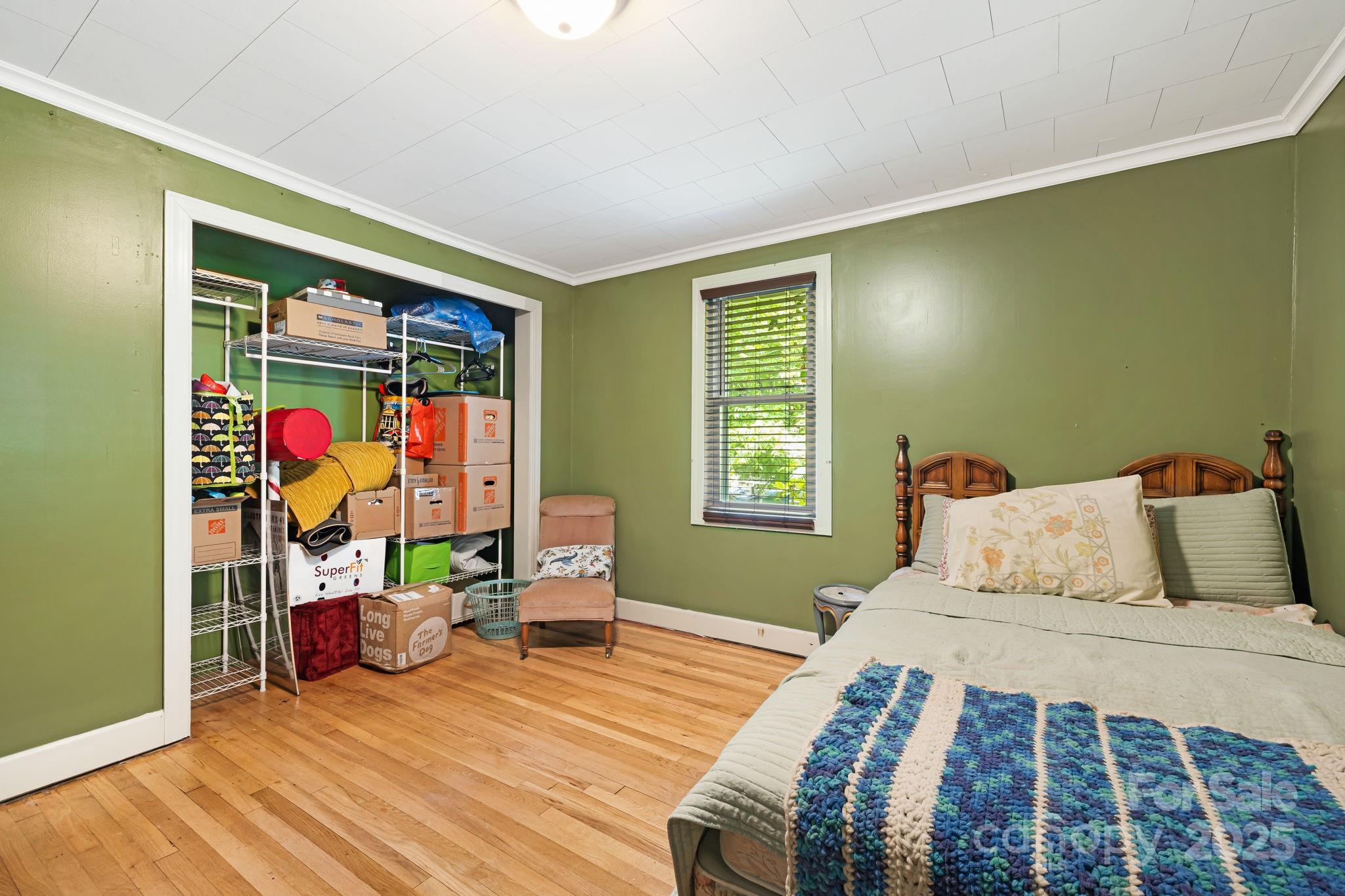 1271 Upper Brush Creek Road Fairview, NC 28730 - Photo 22 of 36 a bedroom with a bed and a window