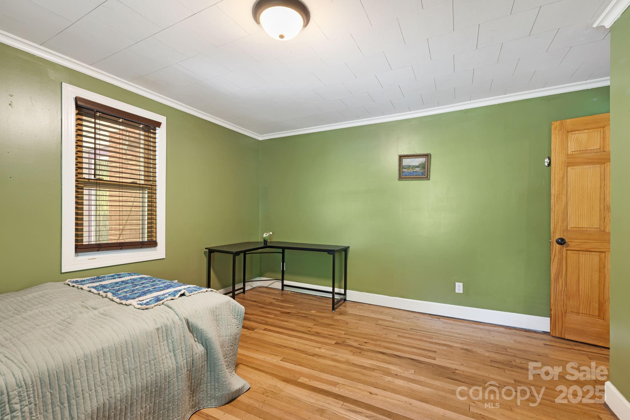 1271 Upper Brush Creek Road Fairview, NC 28730 - Photo 23 of 36 a bedroom with a bed and a window