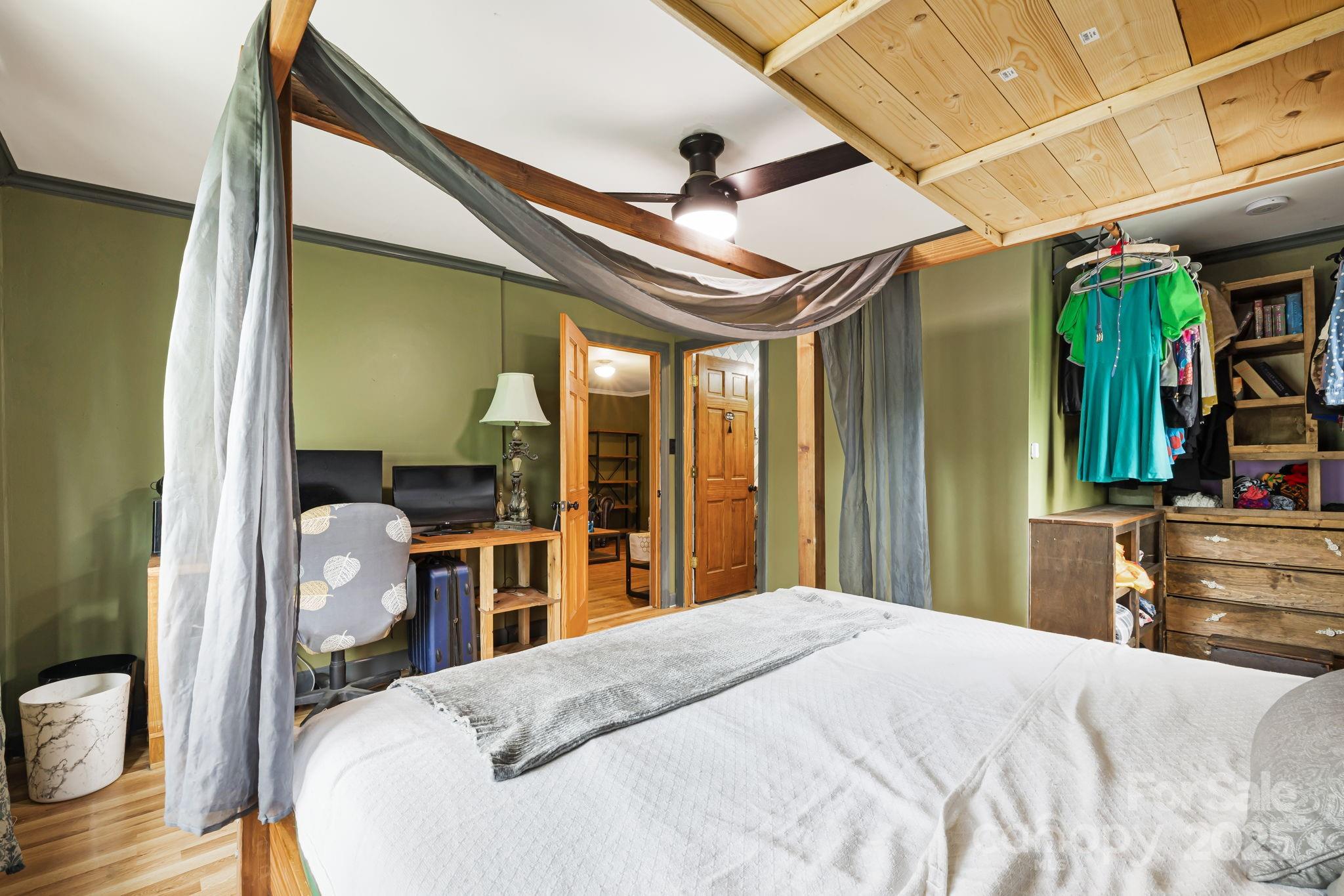 1271 Upper Brush Creek Road Fairview, NC 28730 - Photo 25 of 36 a bedroom with a bed and wooden floor