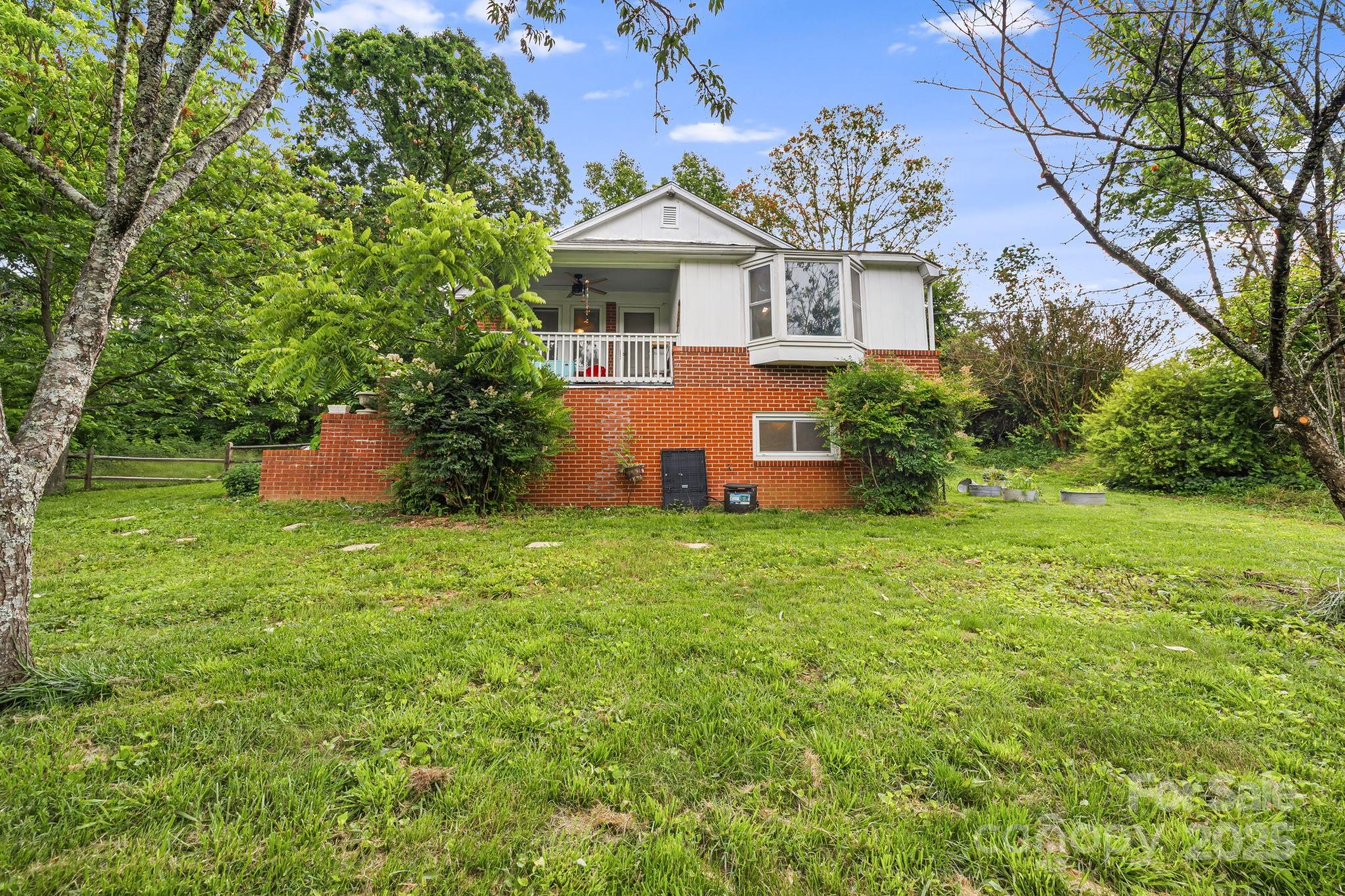 1271 Upper Brush Creek Road Fairview, NC 28730 - Photo 32 of 36 a front view of a house with a garden