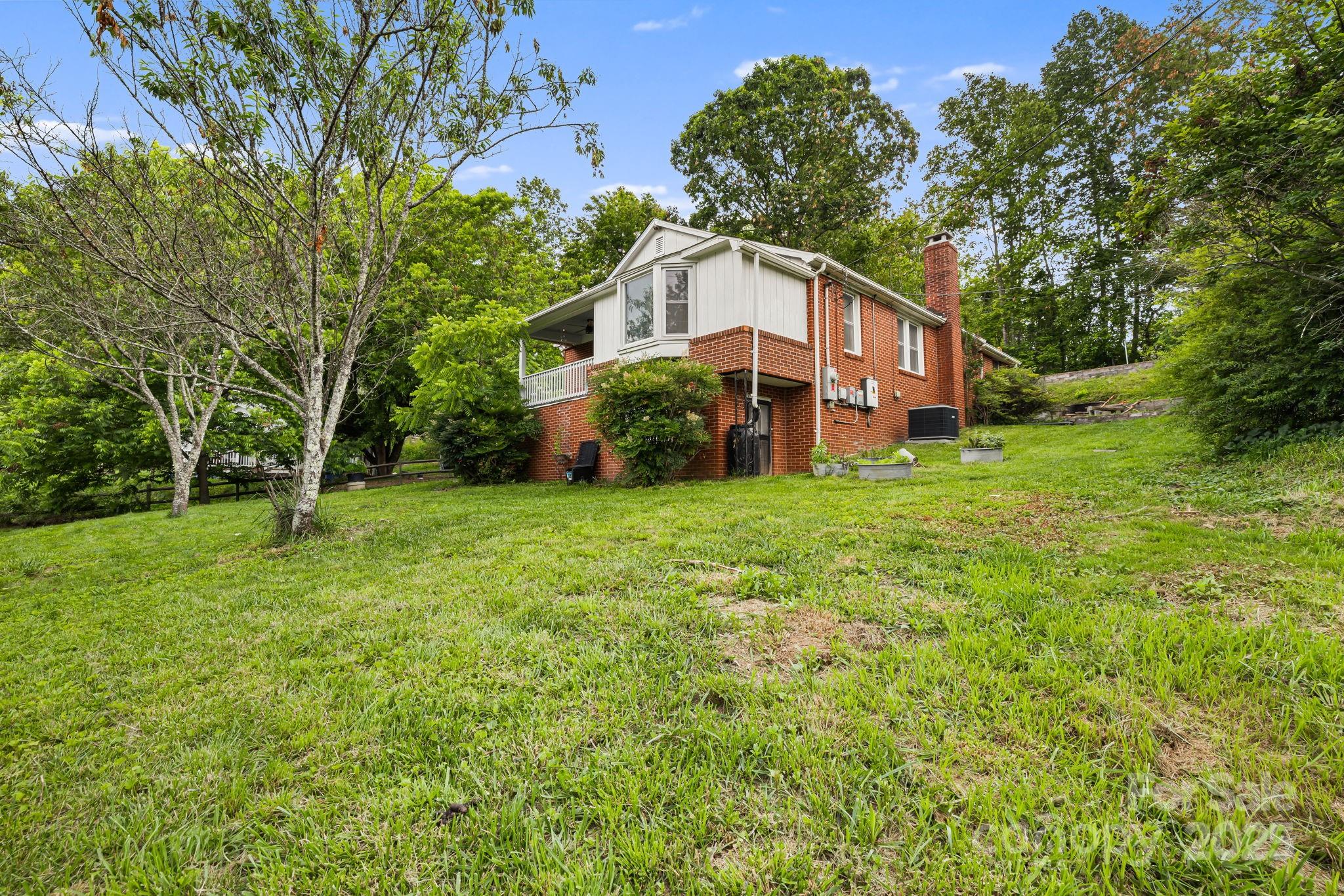 1271 Upper Brush Creek Road Fairview, NC 28730 - Photo 33 of 36 a view of a house with a big yard