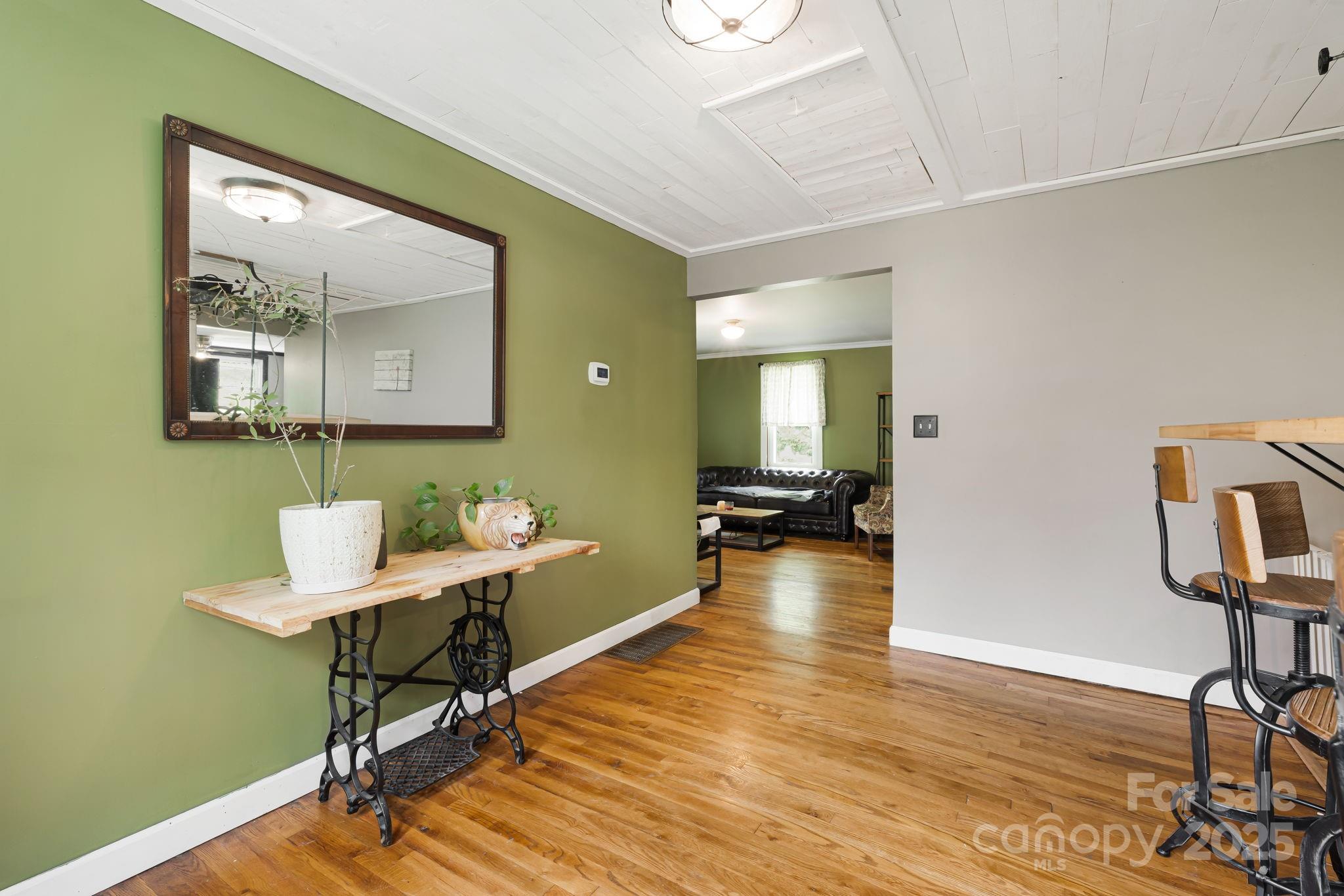 1271 Upper Brush Creek Road Fairview, NC 28730 - Photo 5 of 36 a workspace with furniture and wooden floor