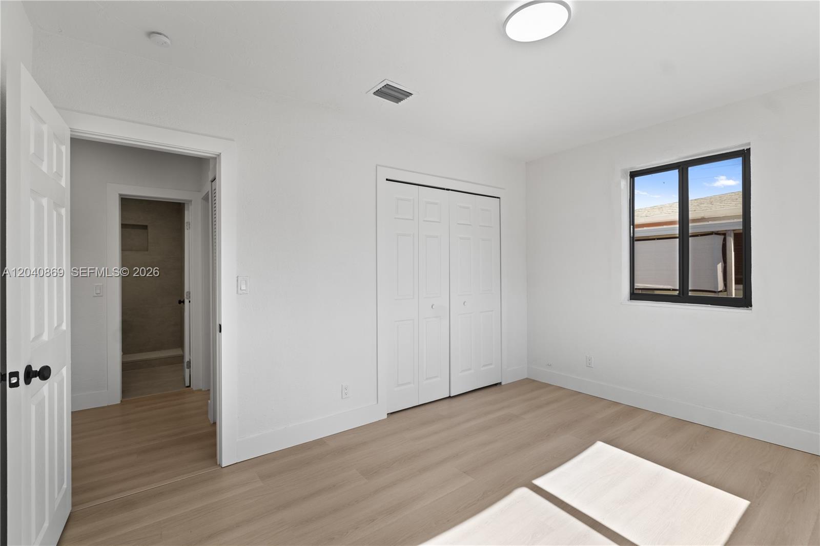 31 West 64th Street Hialeah, FL 33012 - Photo 36 of 49 a view of an empty room with wooden floor and closet