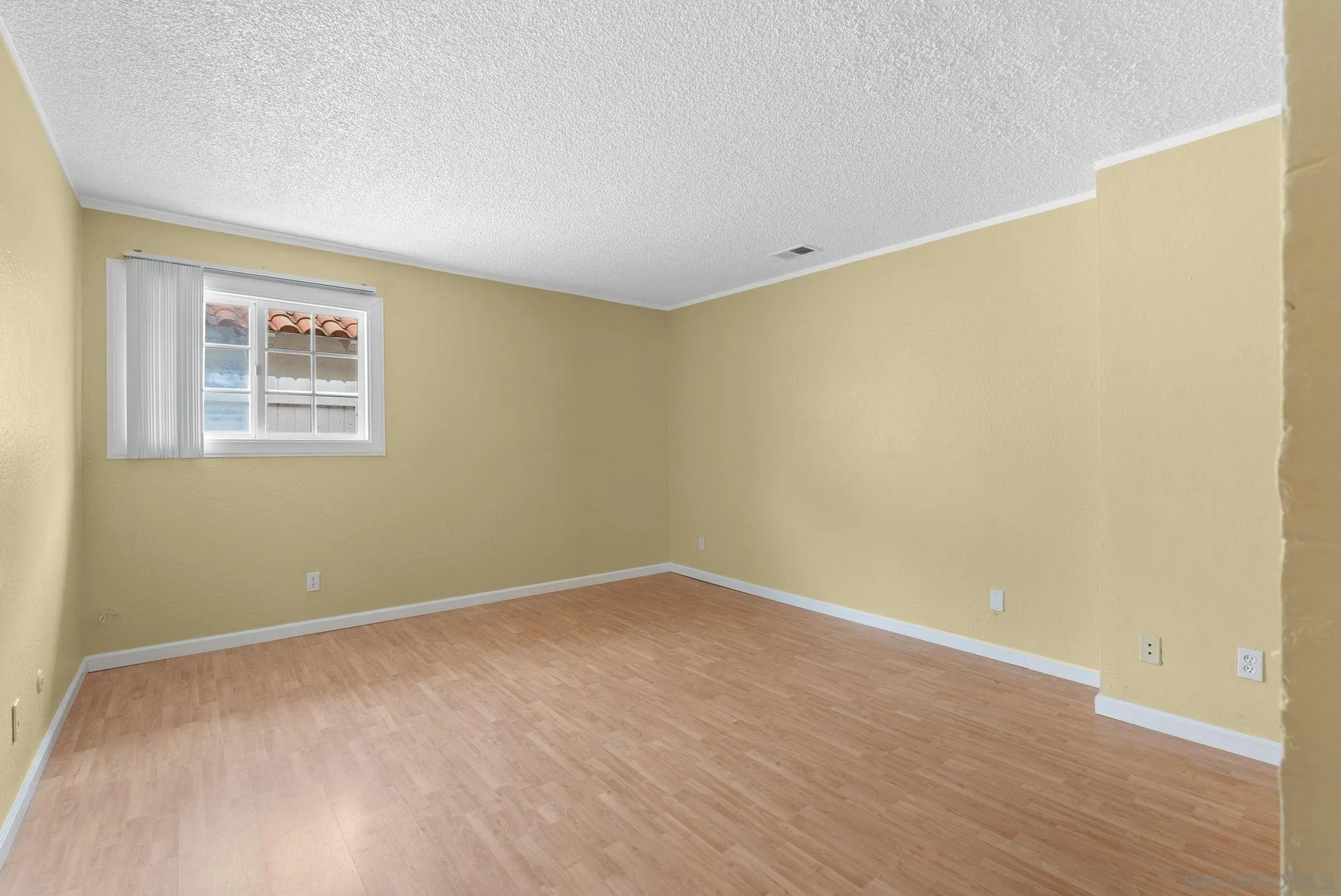 31162 Old River Road Bonsall, CA 92003 - Photo 16 of 44 a view of an empty room with wooden floor and a window