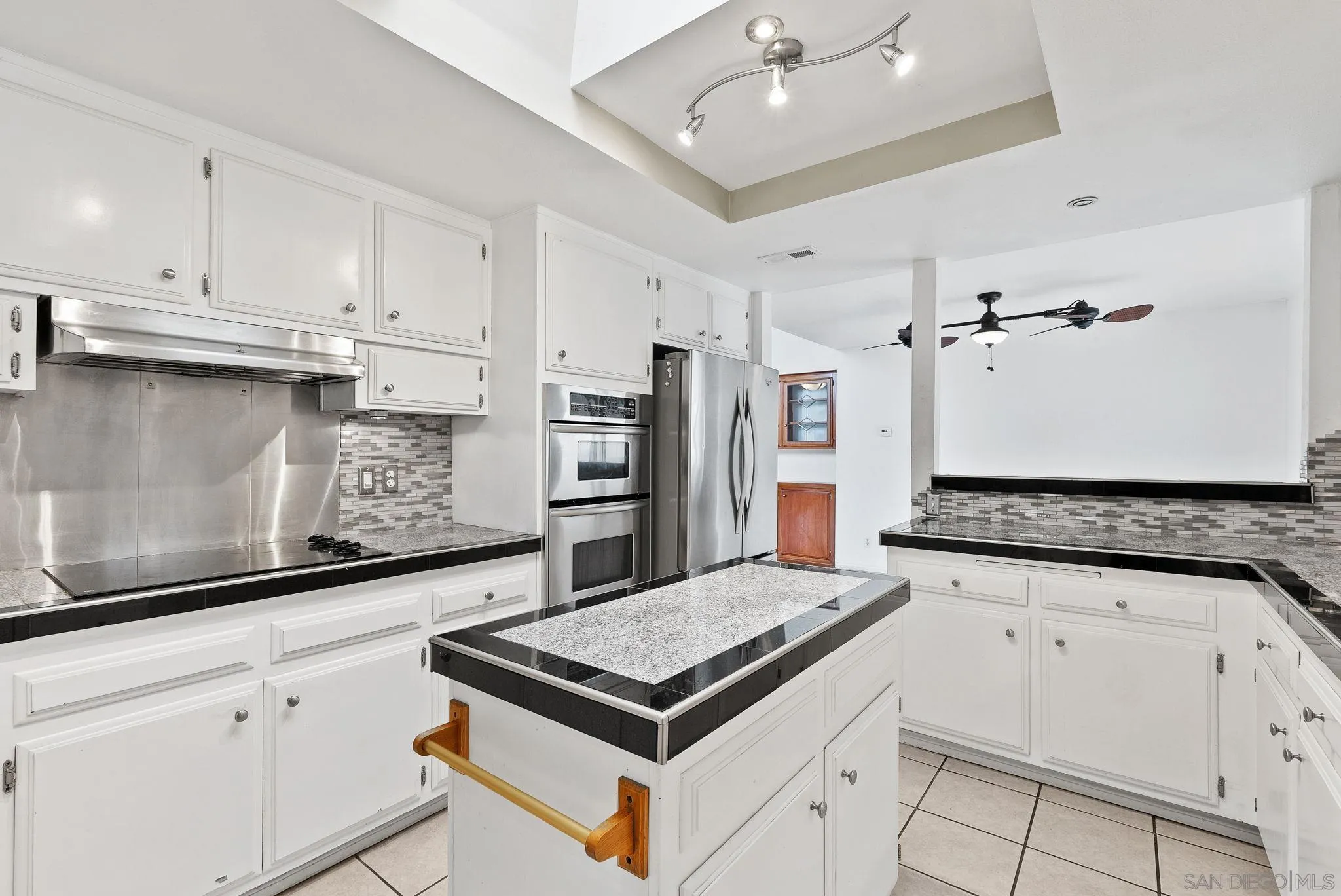 31162 Old River Road Bonsall, CA 92003 - Photo 33 of 44 a kitchen with stainless steel appliances granite countertop a stove a sink and a refrigerator