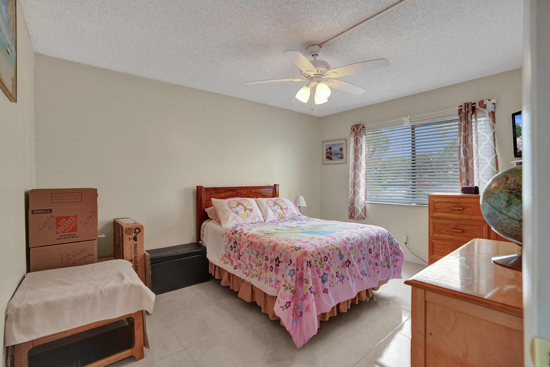 300 Racquet Club Road, Unit 103 Weston, FL 33326 - Photo 18 of 31 a bedroom with a bed and a chandelier