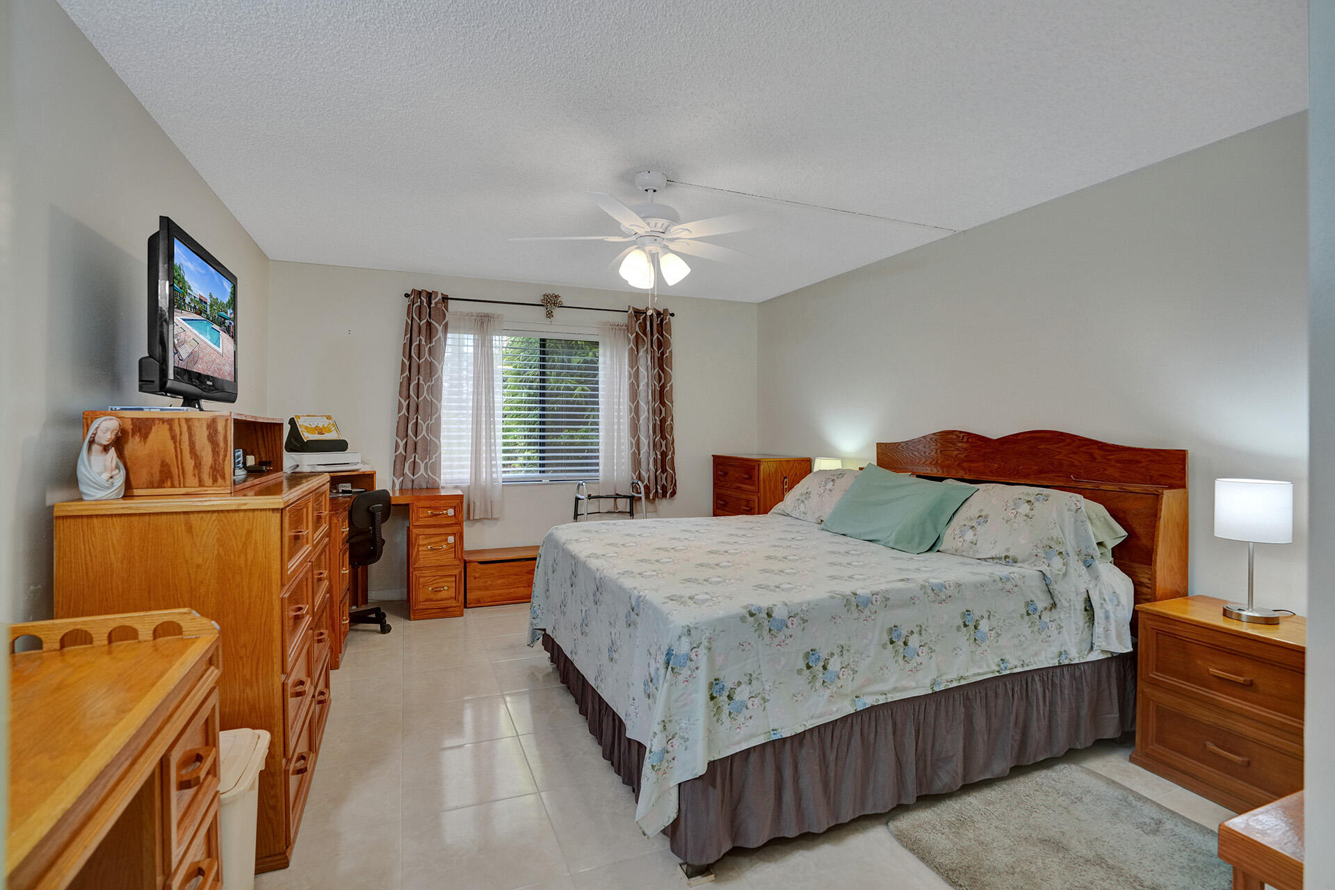 300 Racquet Club Road, Unit 103 Weston, FL 33326 - Photo 21 of 31 a bedroom with a bed and furniture