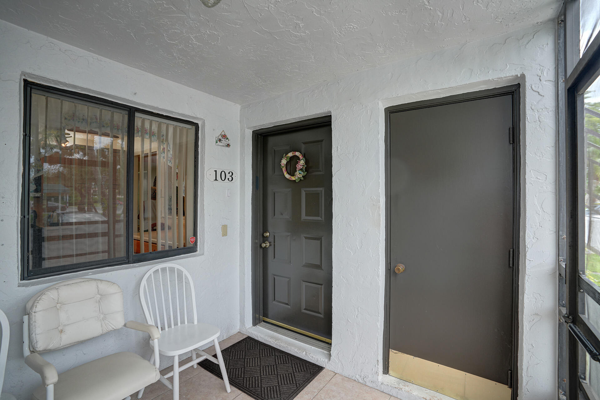 300 Racquet Club Road, Unit 103 Weston, FL 33326 - Photo 4 of 31 a view of a door and chair in a room