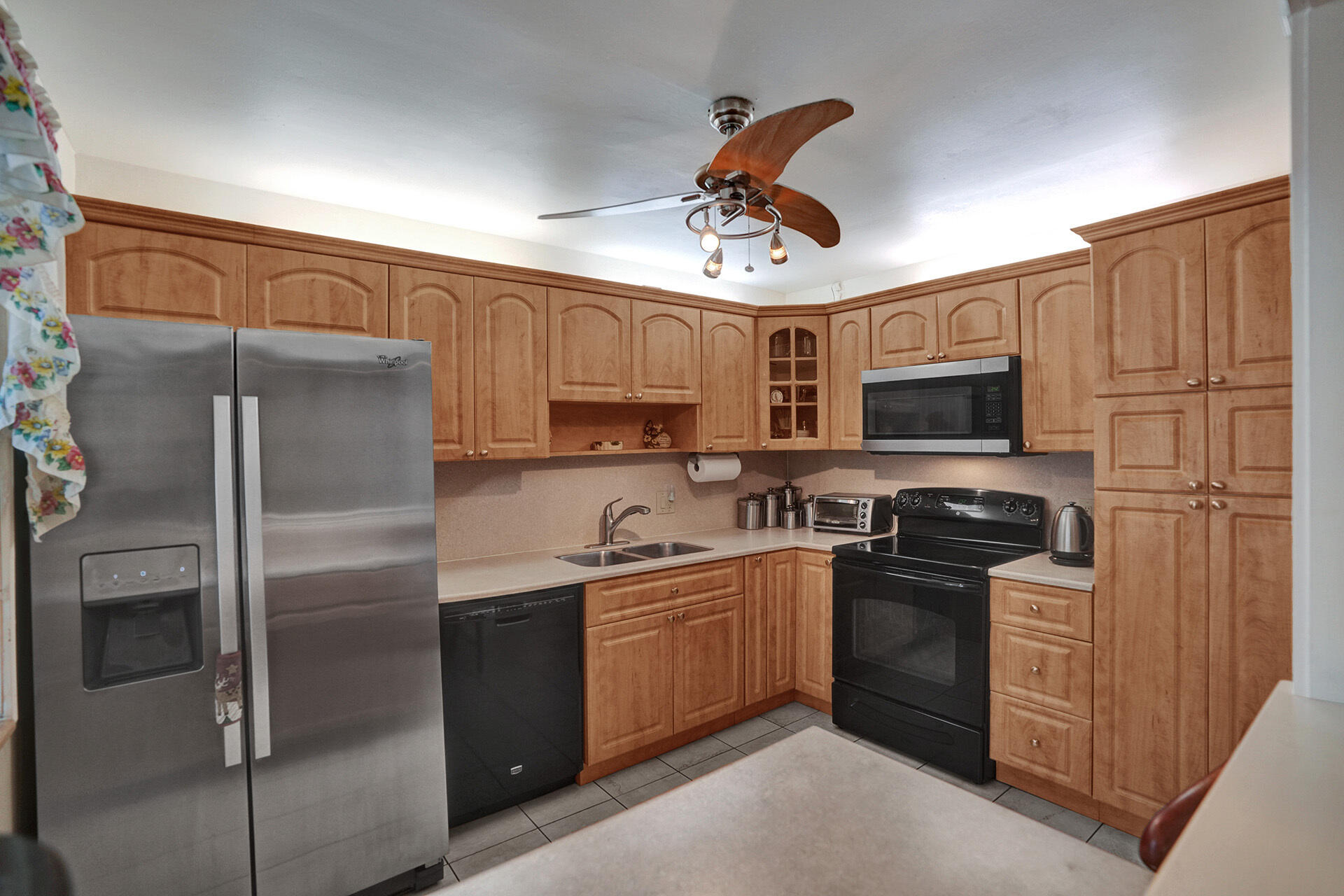 300 Racquet Club Road, Unit 103 Weston, FL 33326 - Photo 7 of 31 a kitchen with stainless steel appliances granite countertop a refrigerator a stove top oven a sink and dishwasher