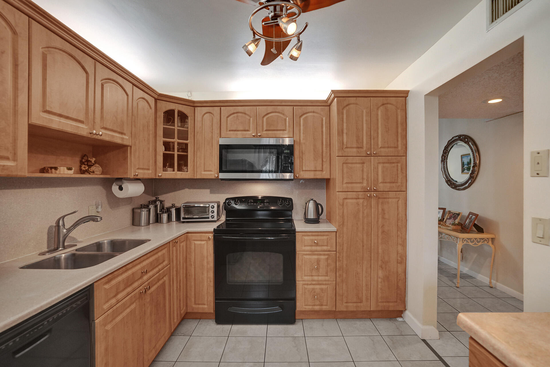 300 Racquet Club Road, Unit 103 Weston, FL 33326 - Photo 10 of 31 a kitchen with stainless steel appliances granite countertop a refrigerator and a sink