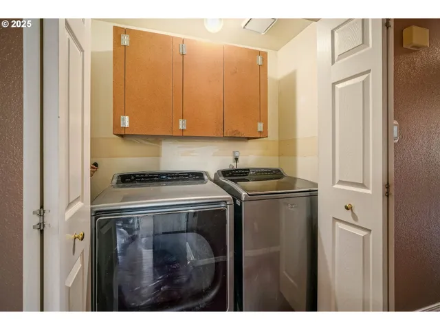 a view of storage and utility room with washer and dryer