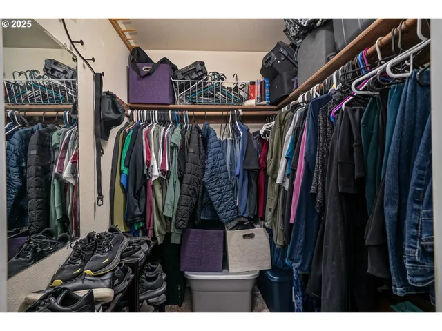 a view of walk in closet with clothes