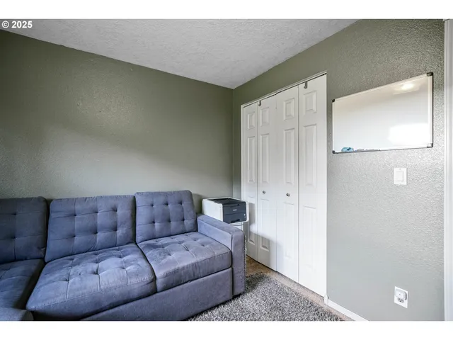 a living room with furniture and a walk in closet