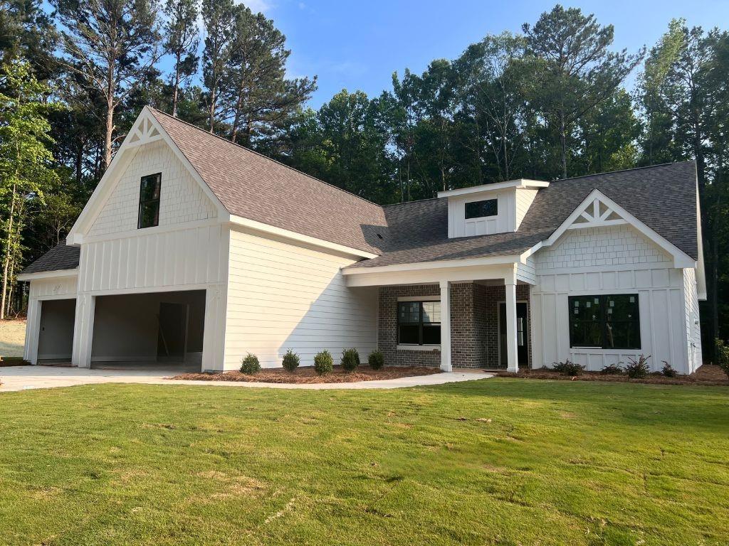 2721 Dry Pond Road Monroe, GA 30656 - Photo 1 of 1 a view of a white house with large windows and a yard