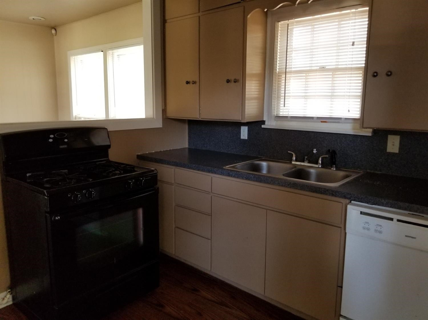 2621 27th Street Lubbock, TX 79410 - Photo 4 of 6 a kitchen with granite countertop white cabinets sink and window