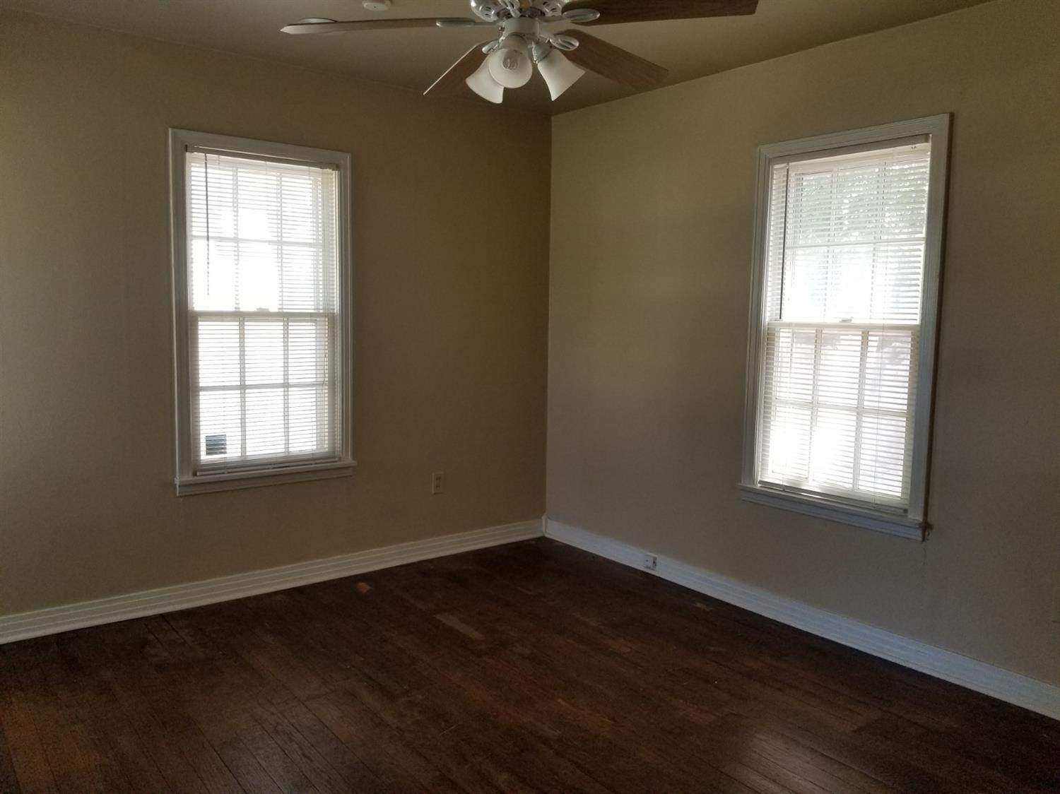 2621 27th Street Lubbock, TX 79410 - Photo 5 of 6 an empty room with wooden floor and windows