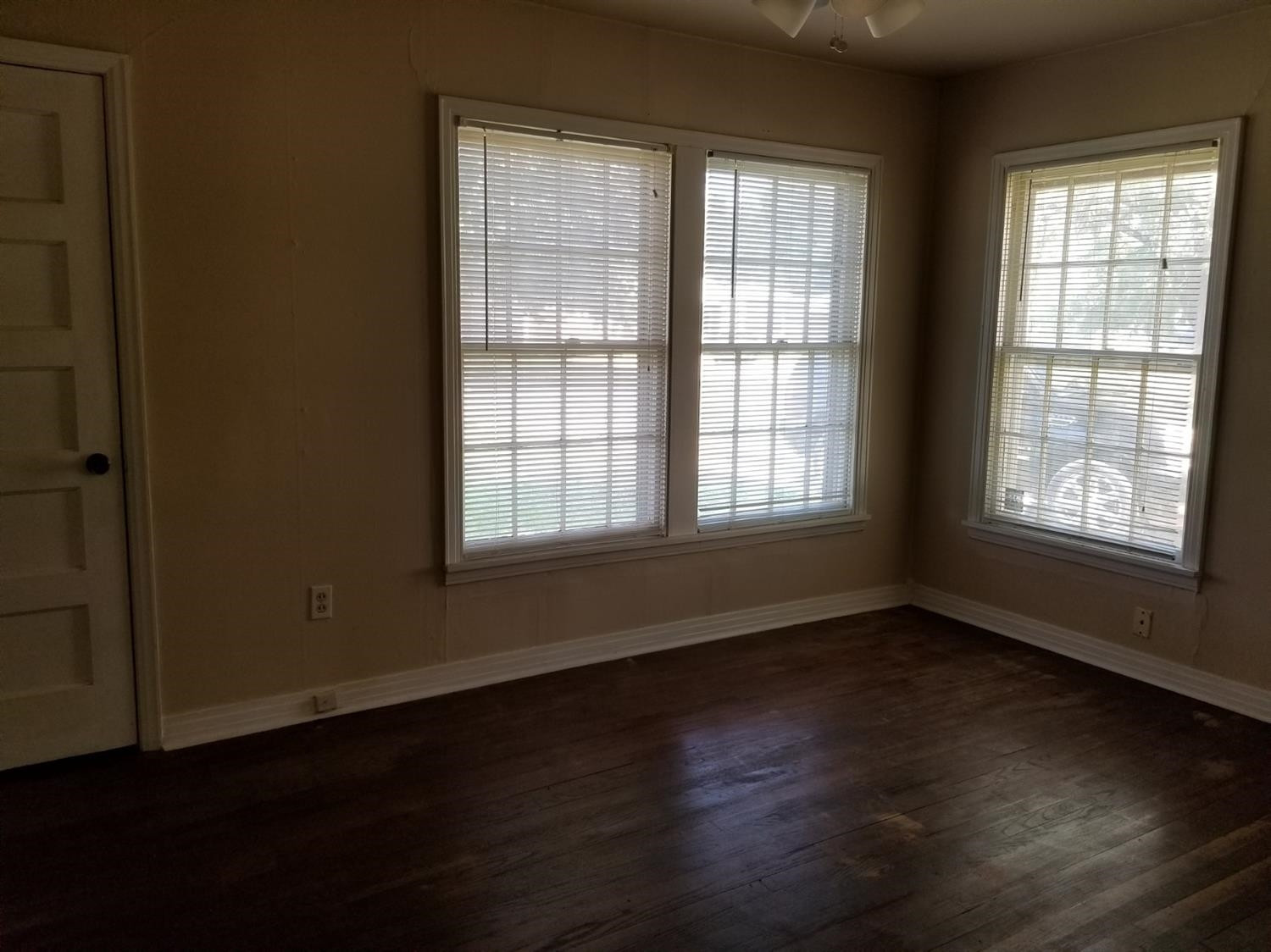 2621 27th Street Lubbock, TX 79410 - Photo 6 of 6 a view of an empty room with wooden floor and a window